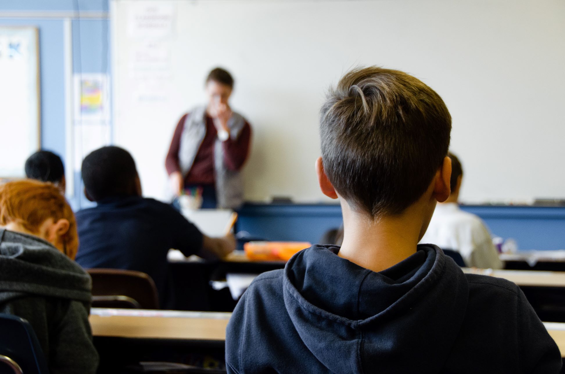 a boy listens in to his French teacher